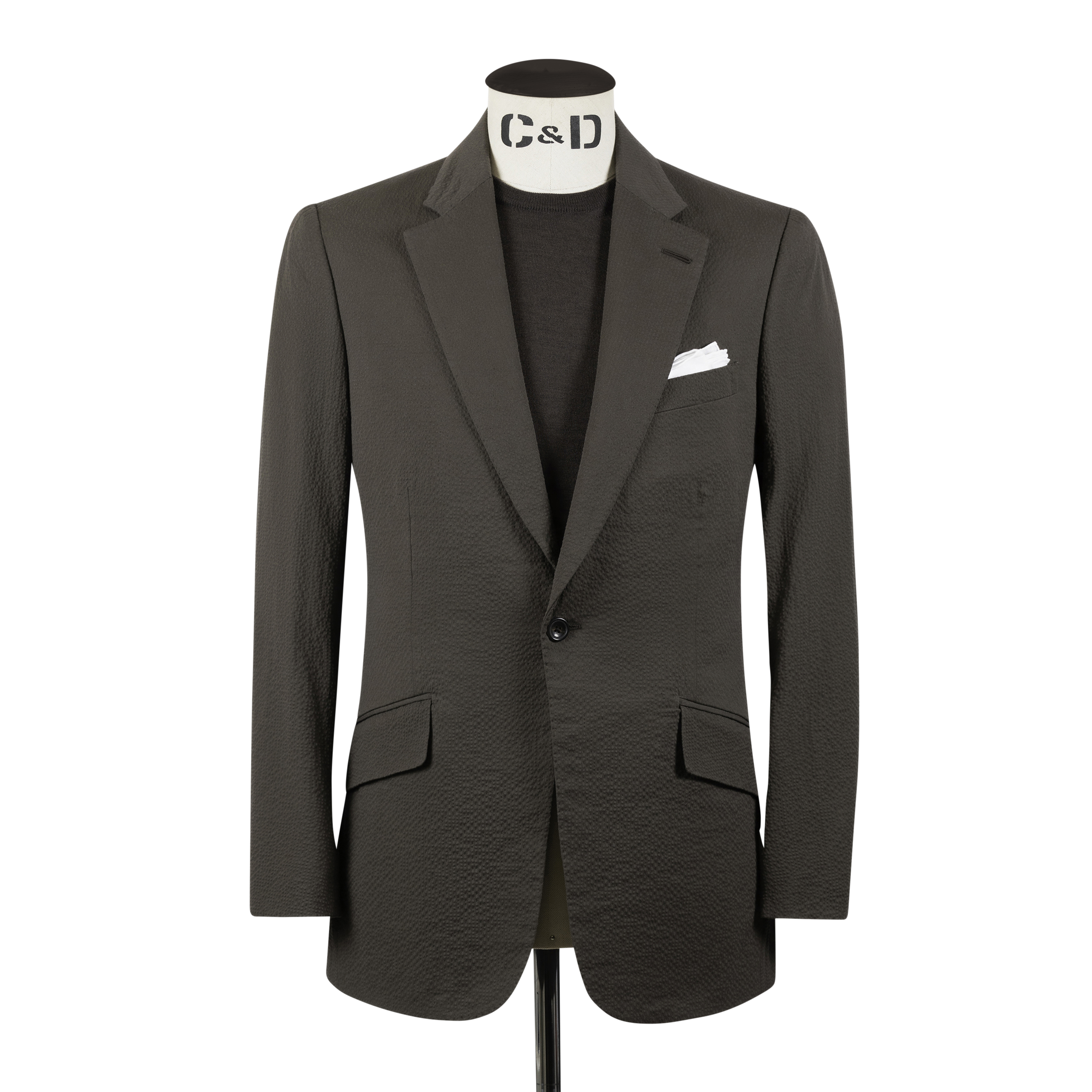 A muted brown cotton seersucker suit with a puckered texture, shown on a model from the front.